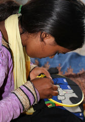 a rural woman embroidering