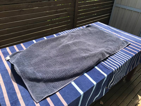 Use towels to create a shade sandwich on a sunny day.