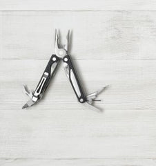 open-toolbox-and-multi-tool-on-wooden-surface-283x300