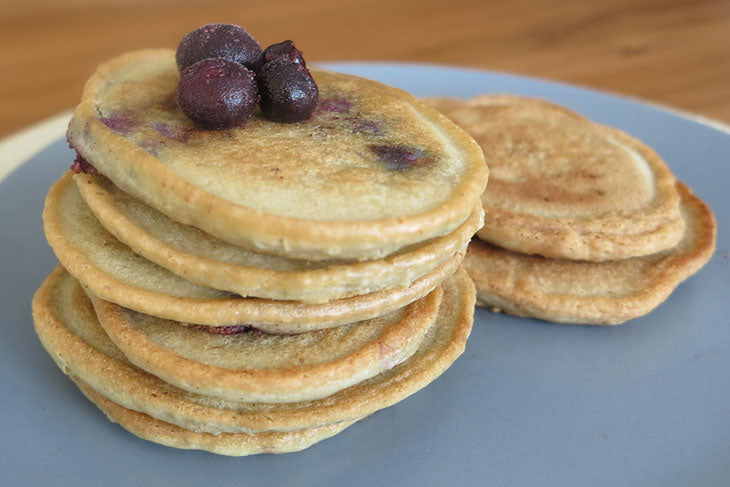 6 ingredient almond flour crumpets topped with frozen blueberries