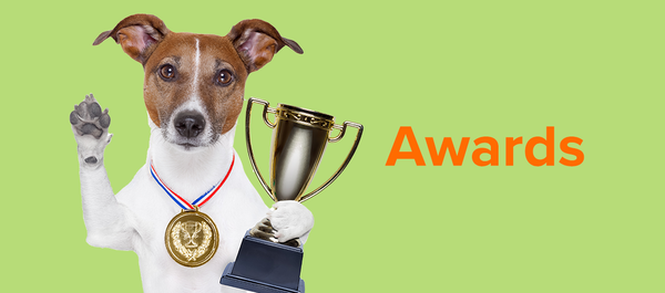 Image of dog holding a trophy