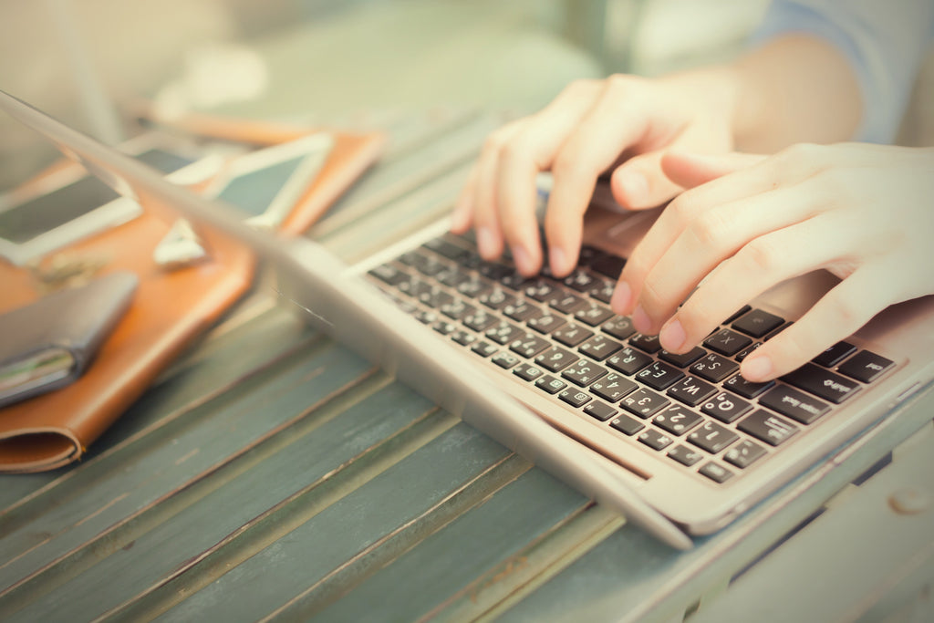 person typing on laptop