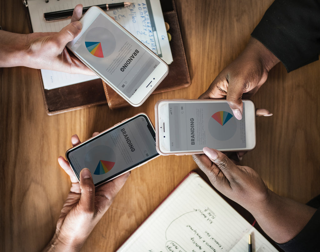 three phones with branding text on the screen