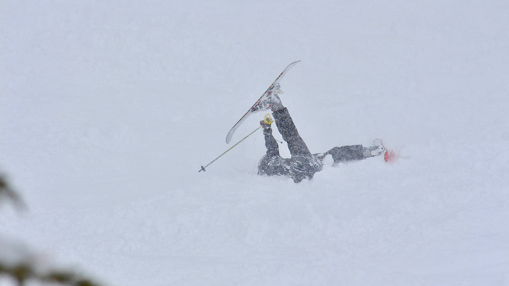 Young skier taking a fall