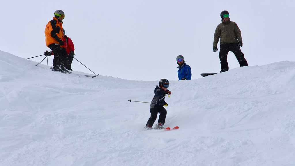 Family skiers and snowboarders ready to hit the slopes