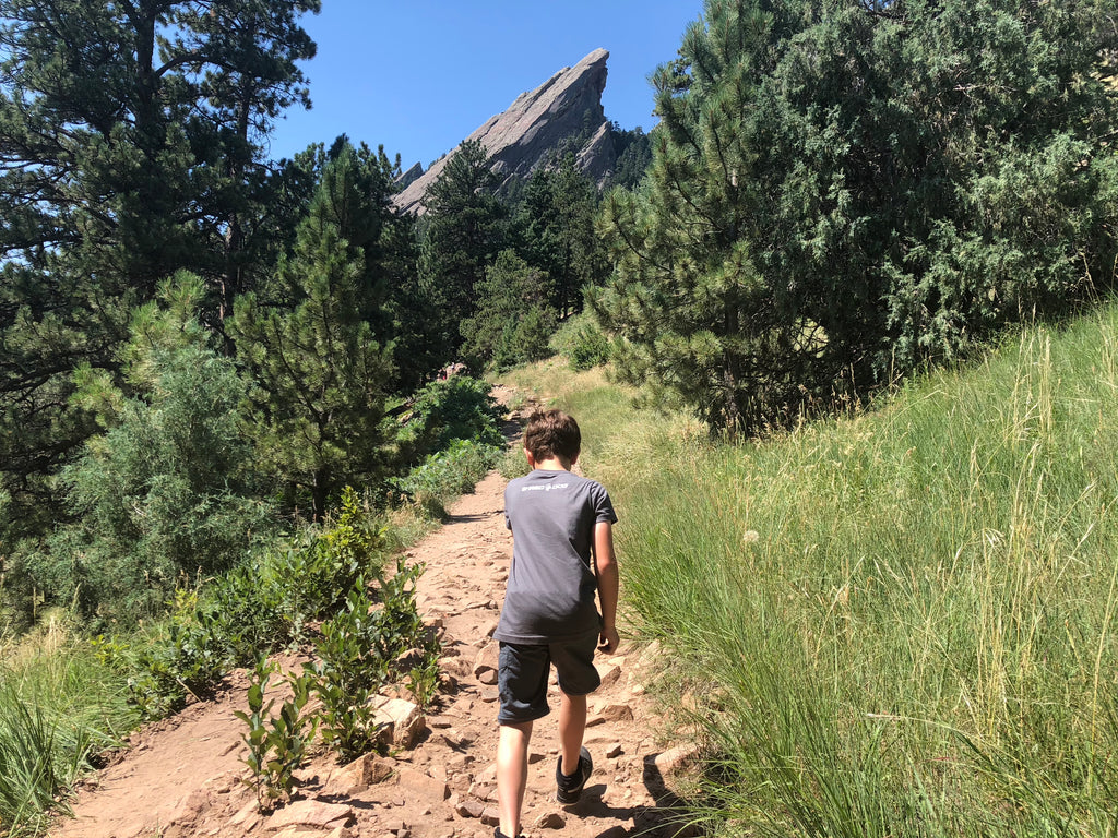 boy hiking to flatirons boulder co