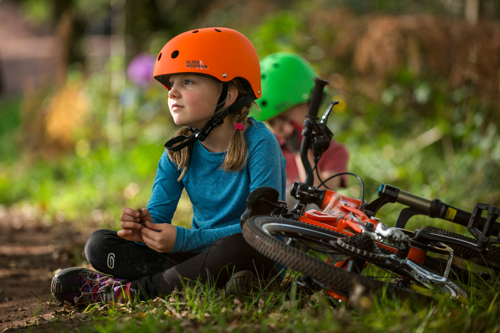 Girl sitting wearing Black Mountain helmet