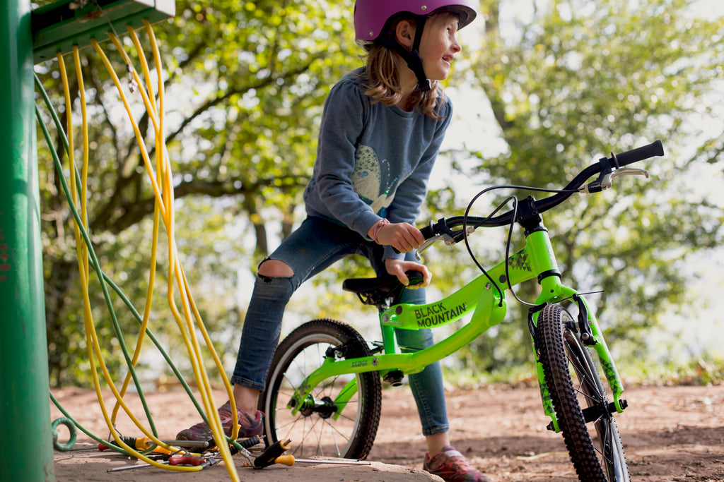 Girl fixing bicycle