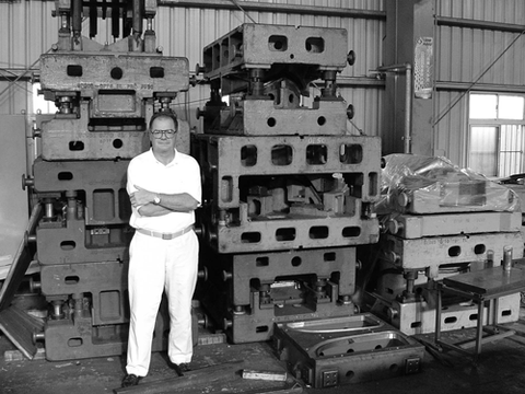 Bob stands with a portion of the tooling for making the 1934 car grille in 2000.