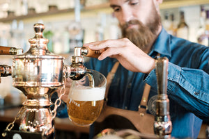 Pouring a Pilsner Urquell using a side pull faucet