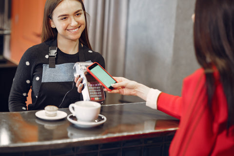 Barista and Customer, Why Your Coffee Shop Needs Social Media (and How to Do it)
