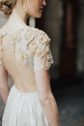 bride with naked back and drop earrings 