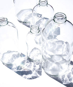 glass bottles with ice cubes