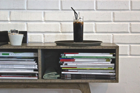 cold brew coffee book shelf with books brick background
