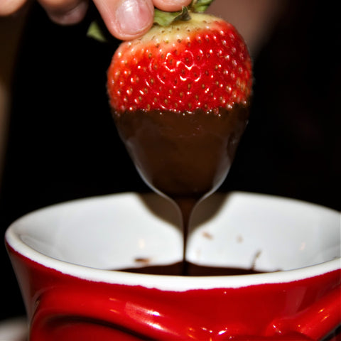 Strawberry dipped in melted chocolate fondue