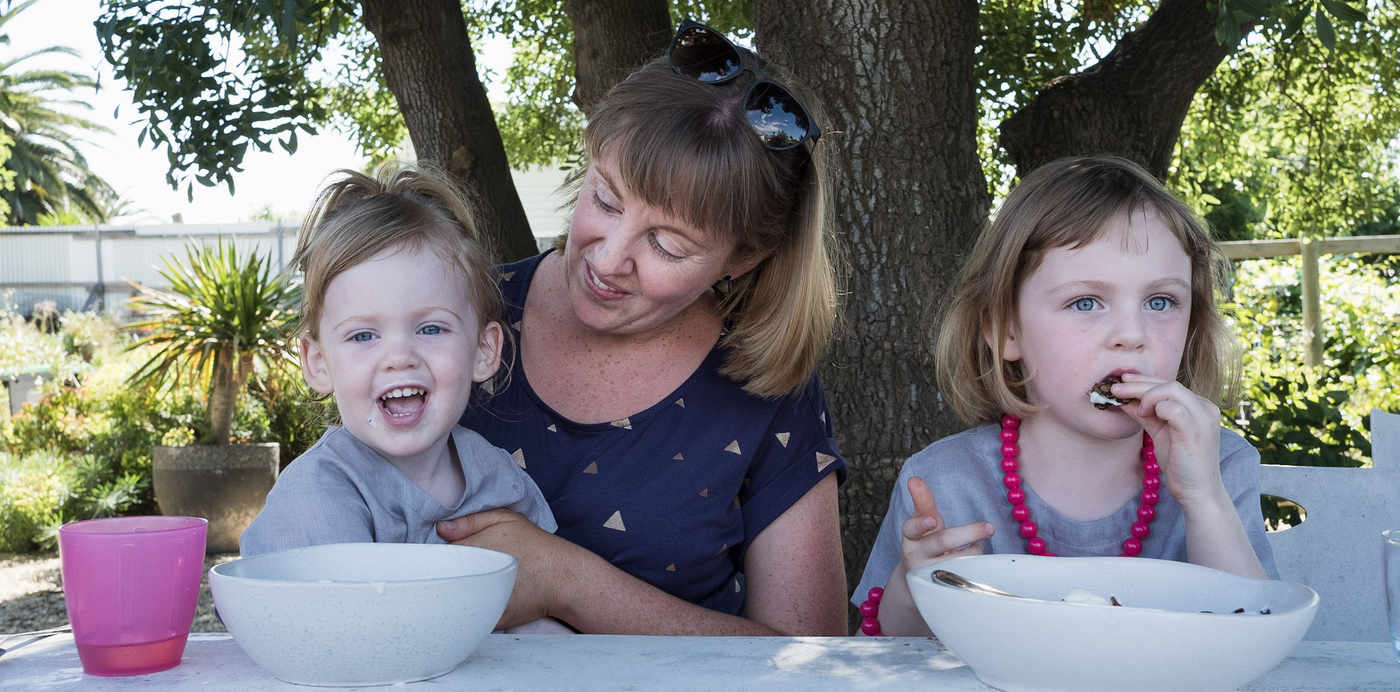 Erin Deimos and her children eating organic granola