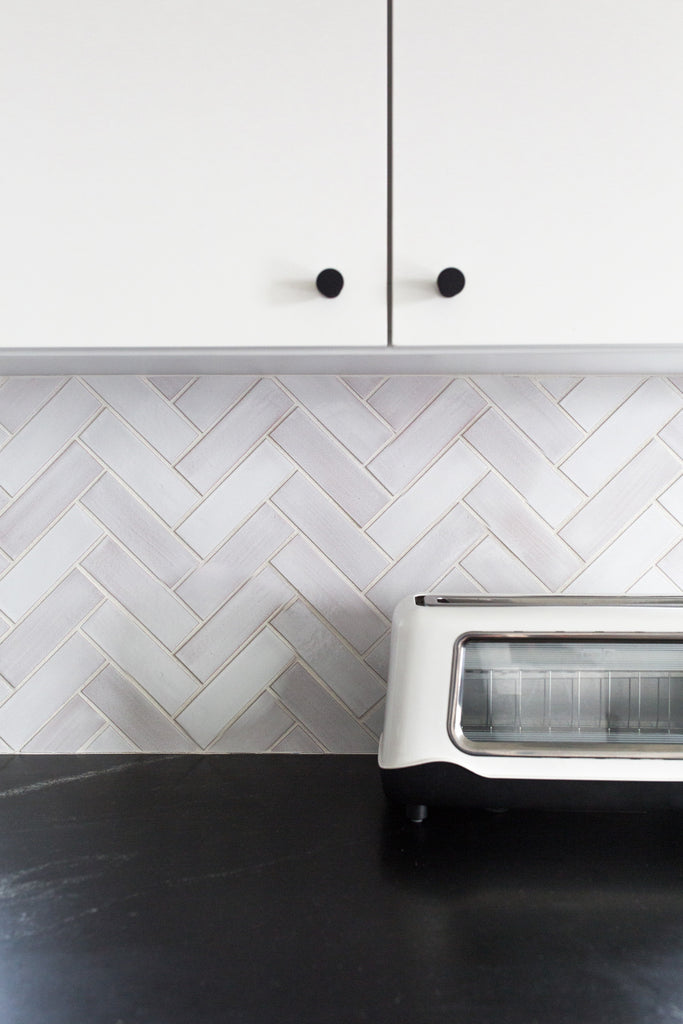 white herringbone kitchen tile backsplash