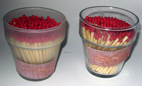 red matches in small flower pot glass vases with a match striker strip on the side
