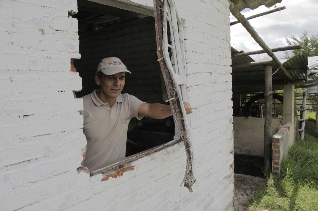 Armando Benavides of Finca Santa Maria inspects damage caused by bandits