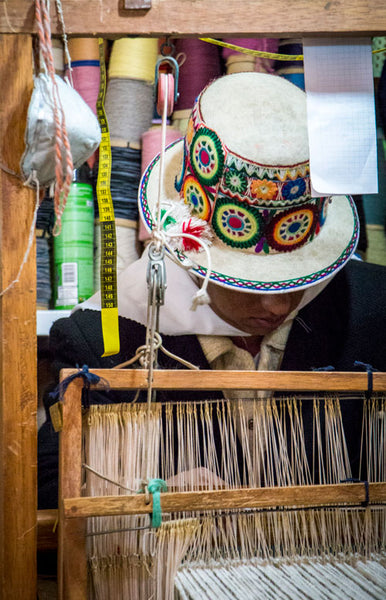 Artisan creating fair trade sustainable clothing on traditional loom