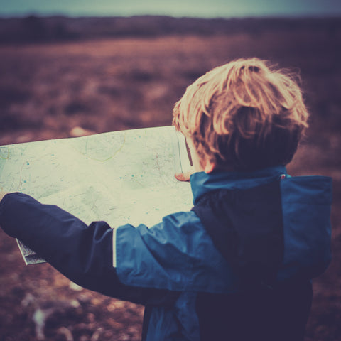 Little boys explores a map - Helicopter Parenting does not give kids the space they need to work things out for themselves