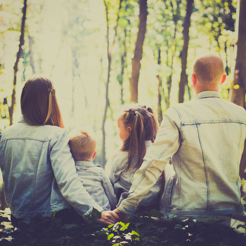 A family slowing down to sit in nature and spend quality time together  - a Slow Parenting approach 