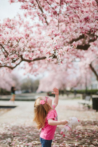 Playing in nature, such as gathering flower petals, is benefical to children