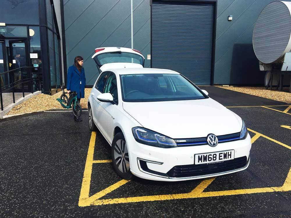 volkswagen e-golf, electric car, ev park and ride with kick scooter