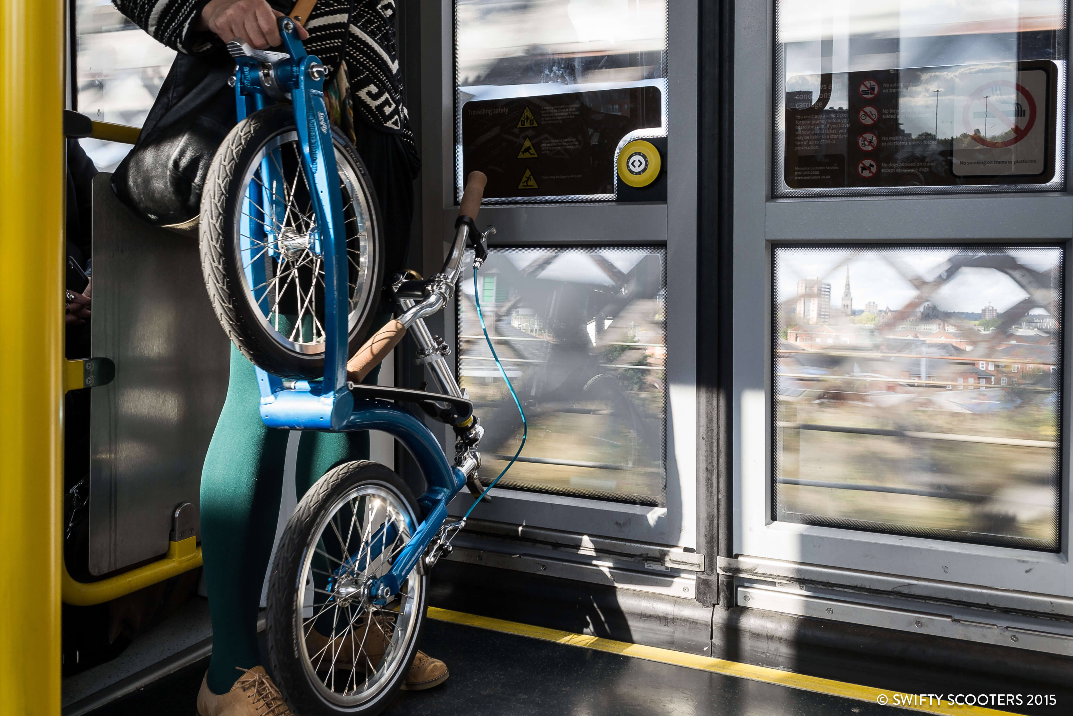 Folding adult urban scooter on tram