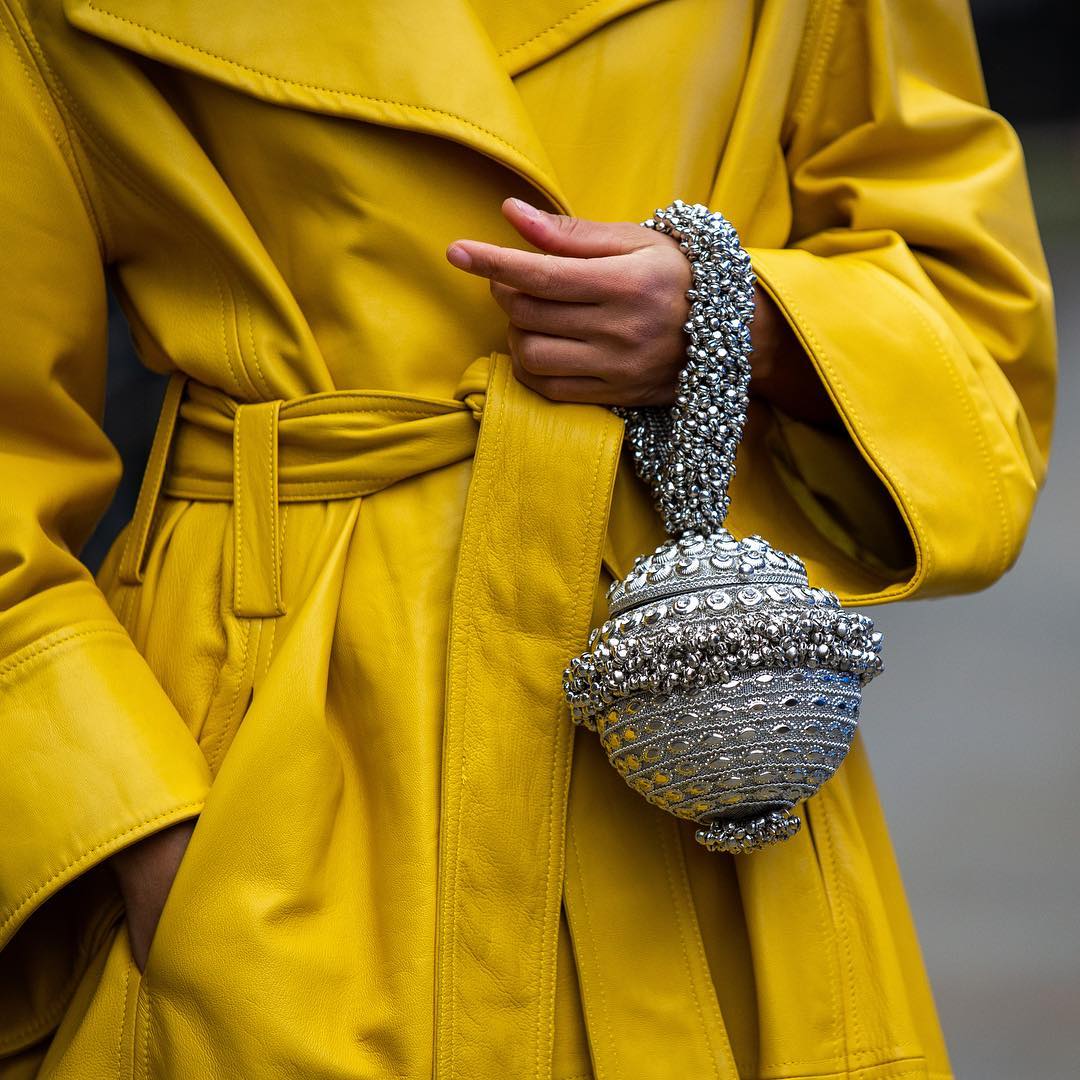 Slip Into Style influencer blogger Ellie Erdem Autumn Winter 2019 show wearing Mae Cassidy at London Fashion Week street style statement styling Silver Simi Sparkle clutch bag white tee head to toe colour Mustard yellow.