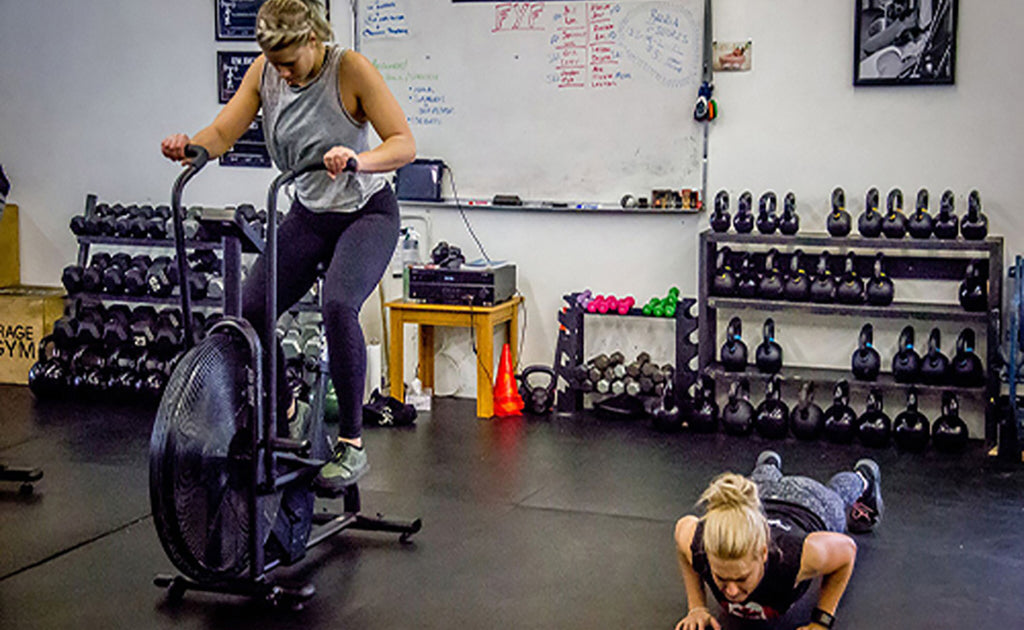 Woman on airdyne bike sweating