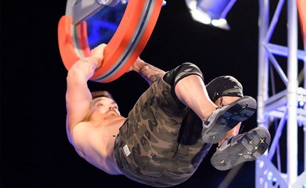 man competing in Ninja Warrior Competition