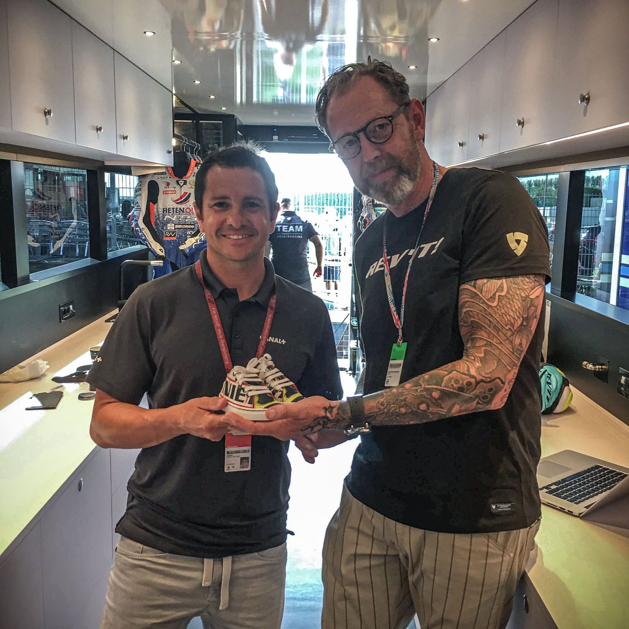 Randy & Jan at SIlverstone 2019 handing over the handmade baby sneakers