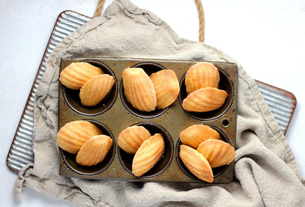 vanilla bean, spice and brown butter madeleines in a baking sheet pan