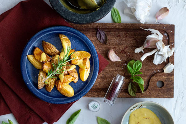 saffron, saffron aioli and crispy potatoes with fresh herbs and spices on a table