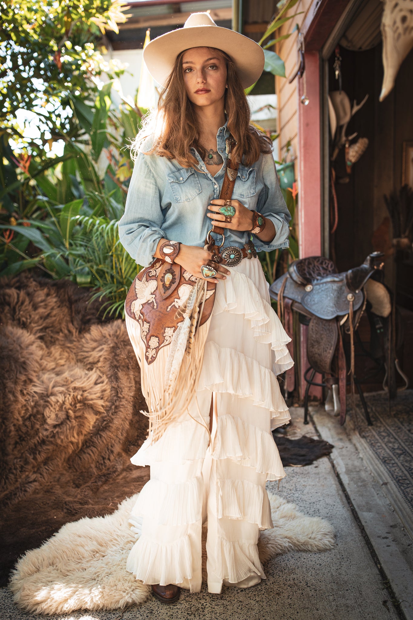 Buffalo Girl denim shirt, white skirt, painted leather bag with cream suede tassels