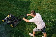Aerial shot of a man mowing the lawn