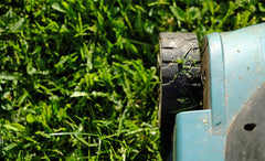Lawnmower cutting grass close up
