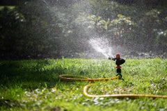 Sprinkler system watering green grass
