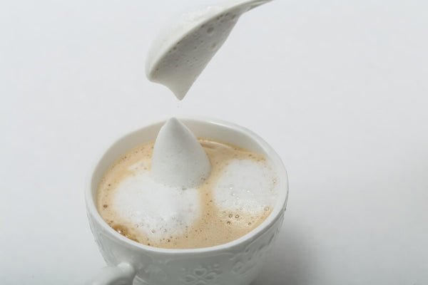 topping tea with milk foam