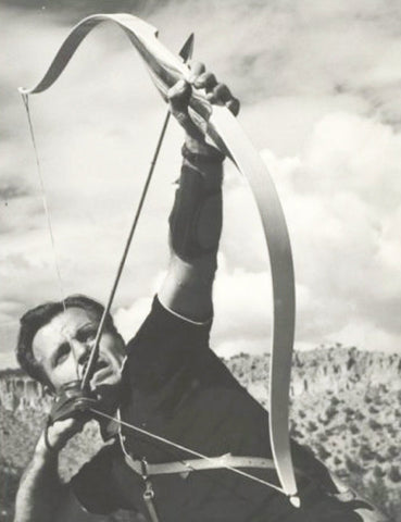 Harold Groves, 1959 shooting a recurve. Notice the arc at the top of the limbs facing away from the archer. Notice also the thick “grip” on the bow.
