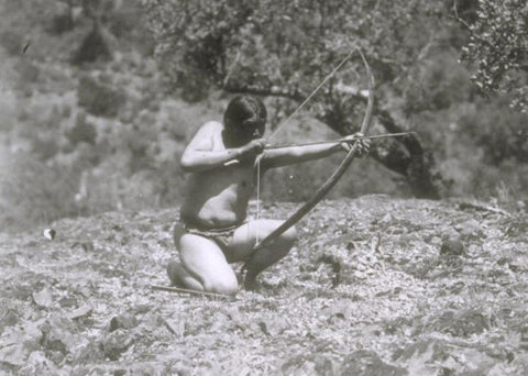 Ishi shooting his bow. His short bows only had a slight recurve which would be hard to see in full draw.