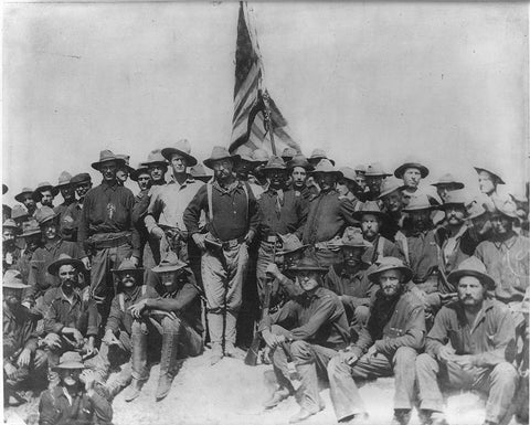 Roosevelt with his Rough Riders atop San Juan hill. He is seen without his 1895 Winchester because he gave it to another soldier who arrived late and was without a rifle.
