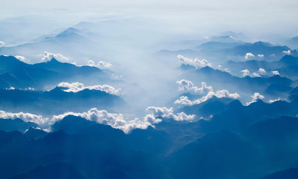 misty clouds and mountain tops in blue hues, meditation