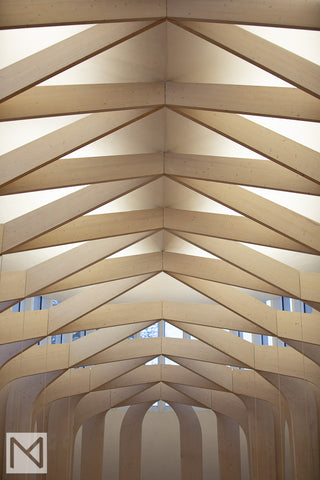 The pale wooden beams crisscross at the ceiling creating a light secondary structure © Nick Miners Photography
