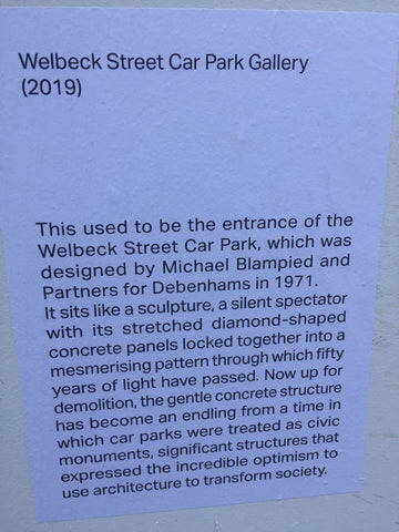 Sign announcing the gallery on hoardings at Welbeck Street Car Park in London