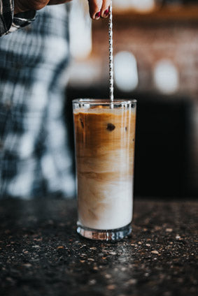 iced coffee in tall glass with straw