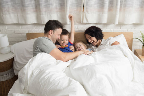 parents-with-kids-in-bed