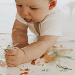 baby having fun with finger paint