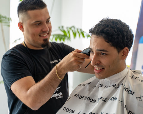 Claudio the barber fades Reebok headquarters representing Fade Room barbershop
